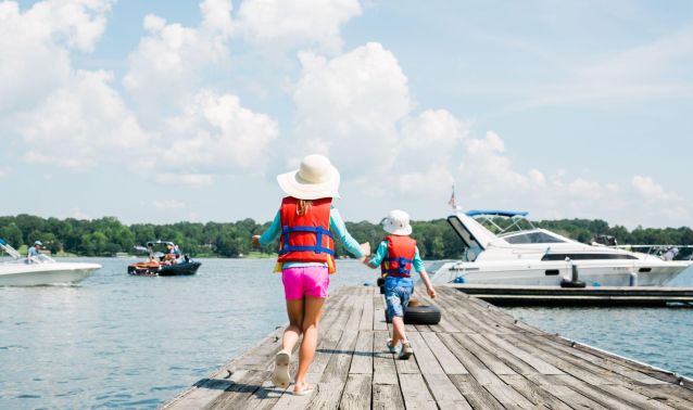 Children walking on a dock.