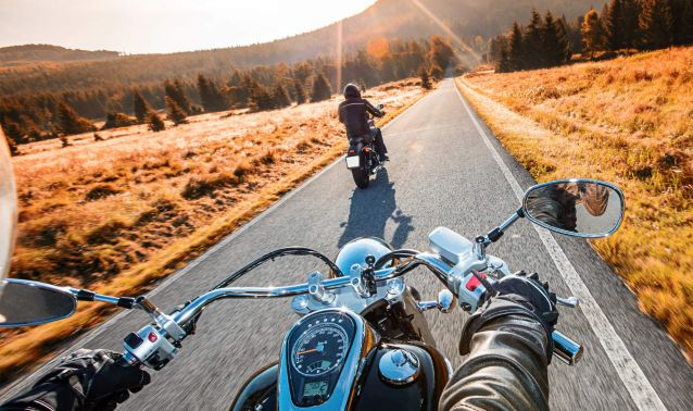Motorcycle on open road in fall