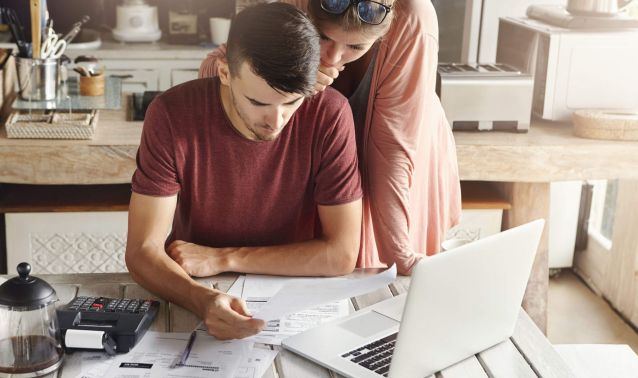 Young Couple at Desk Looking at Finances