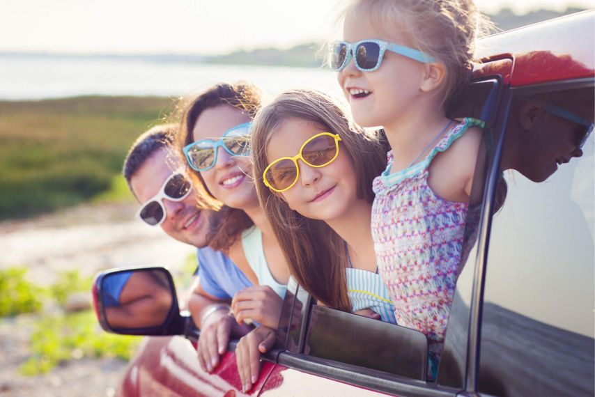 Young Family Looking Out Car in Summer