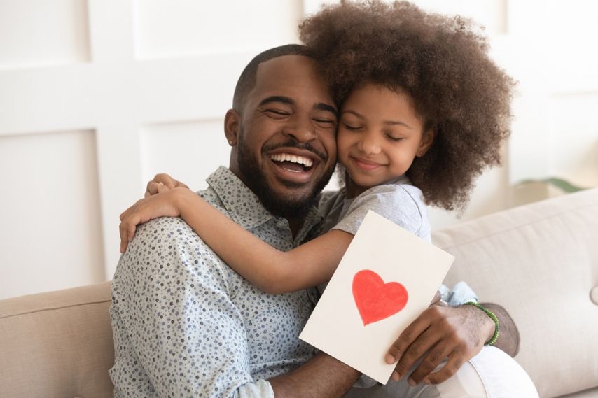 Young daughter hugs father