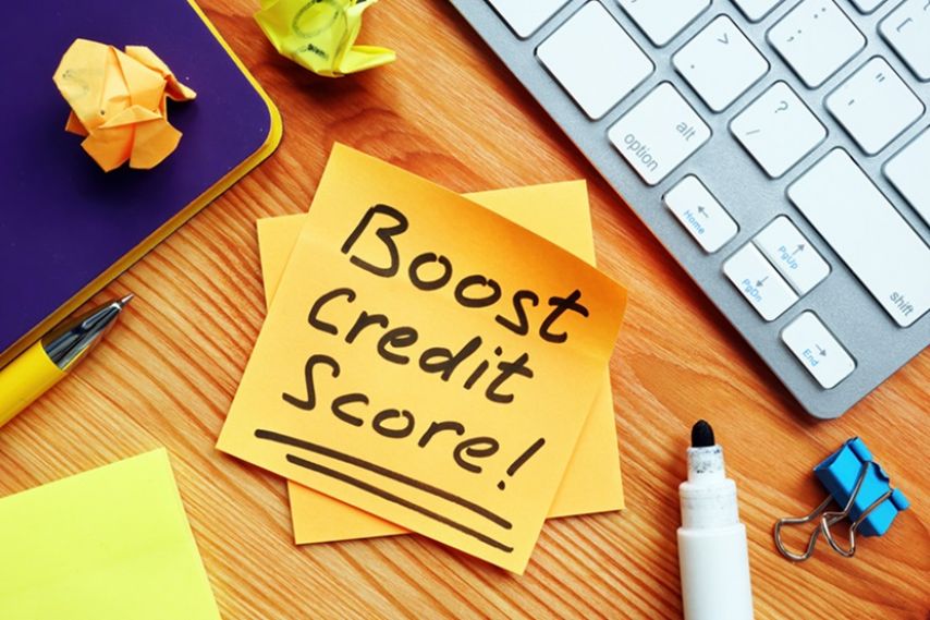 Post-it note with "Boost credit score" written on it.