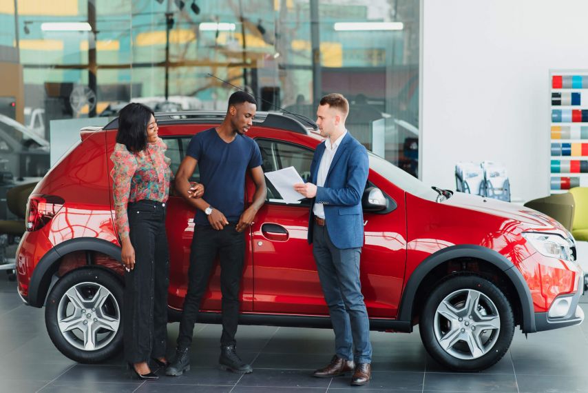 Couple buying car at dealership 1