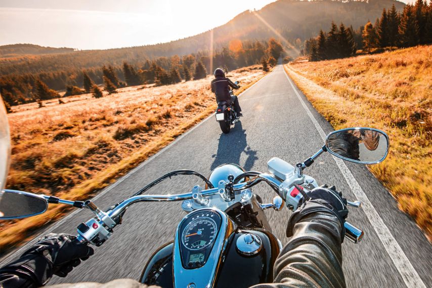 Motorcycle on open road in fall