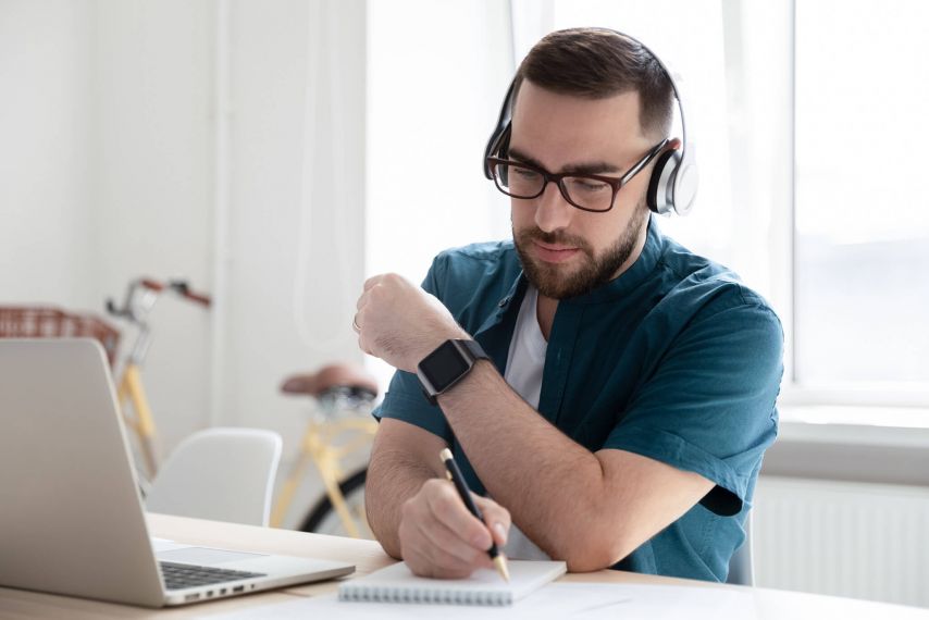 Young man at laptop with headphones