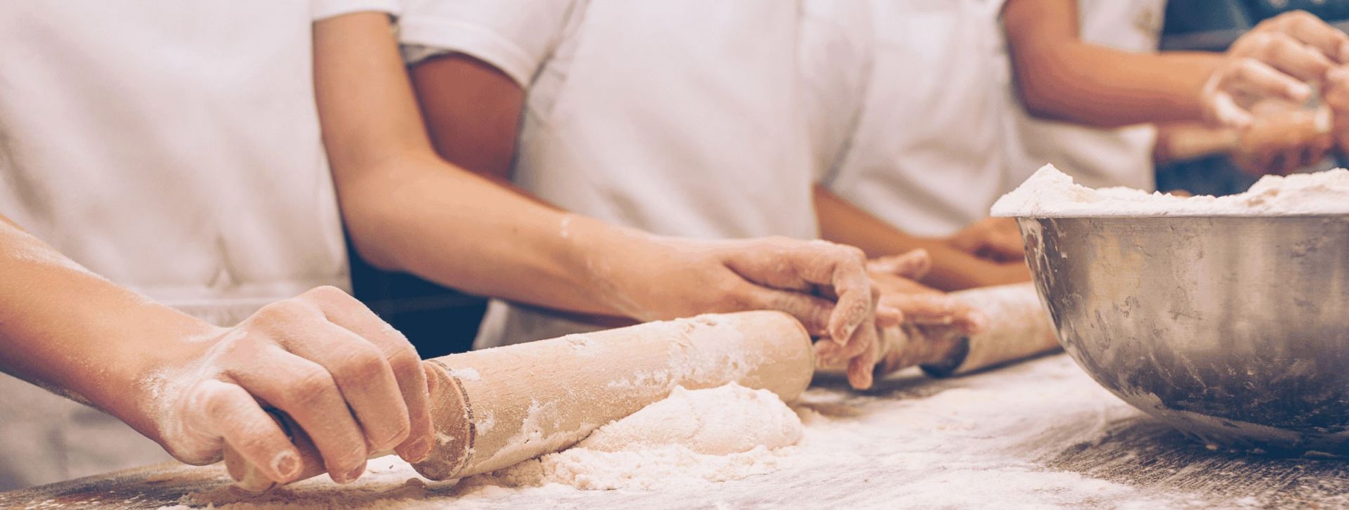 Rolling pin rolling out dough on cutting board